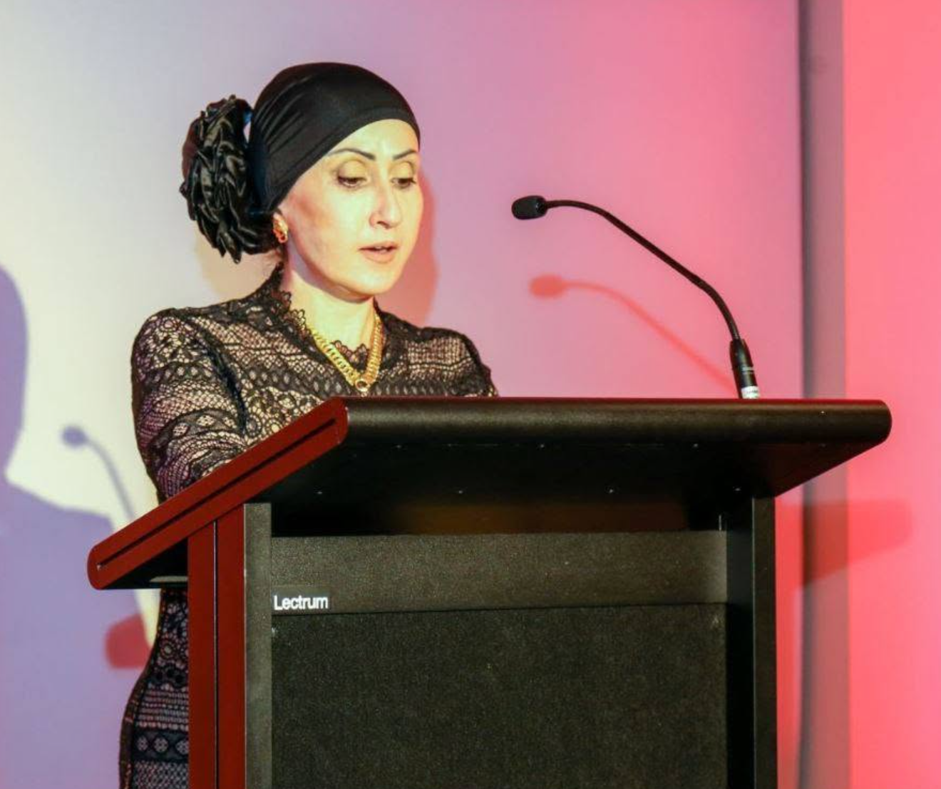 Abeer Alsadoon speaking at a podium